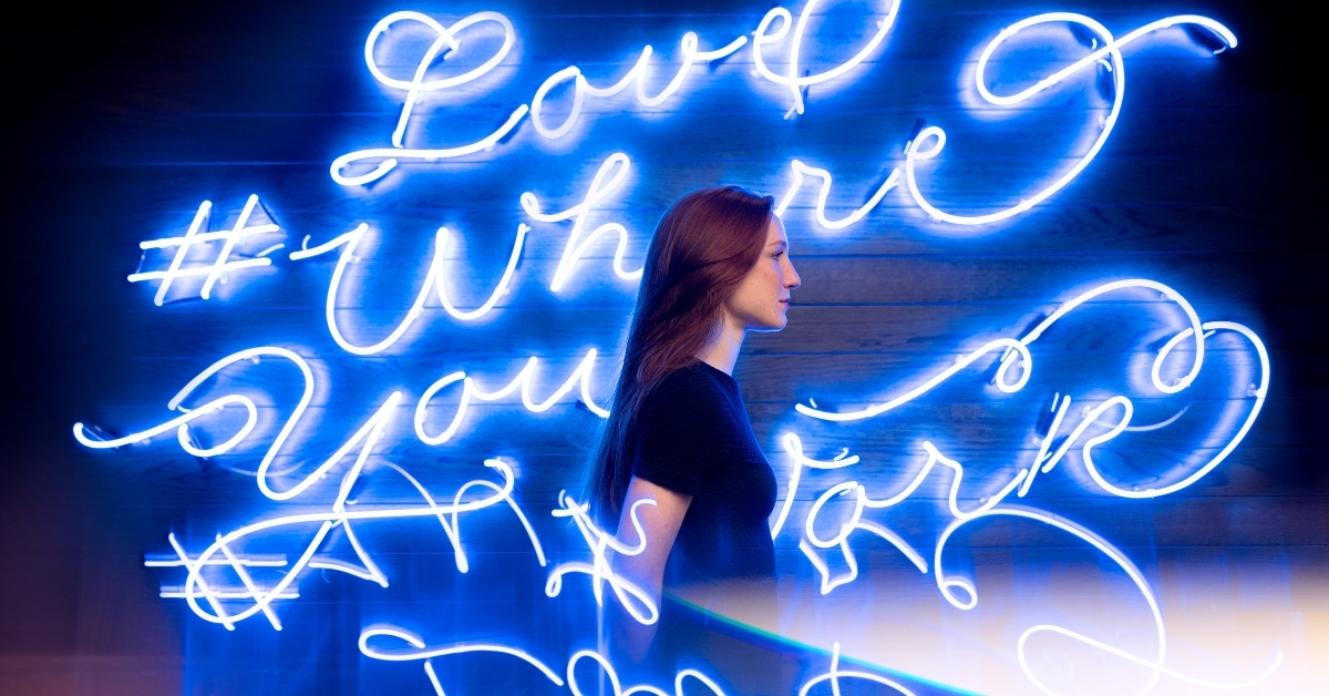 Woman walk in front of neon wall