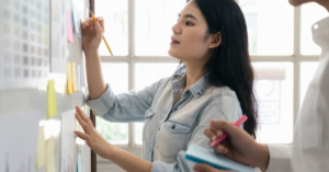 woman writing on post note